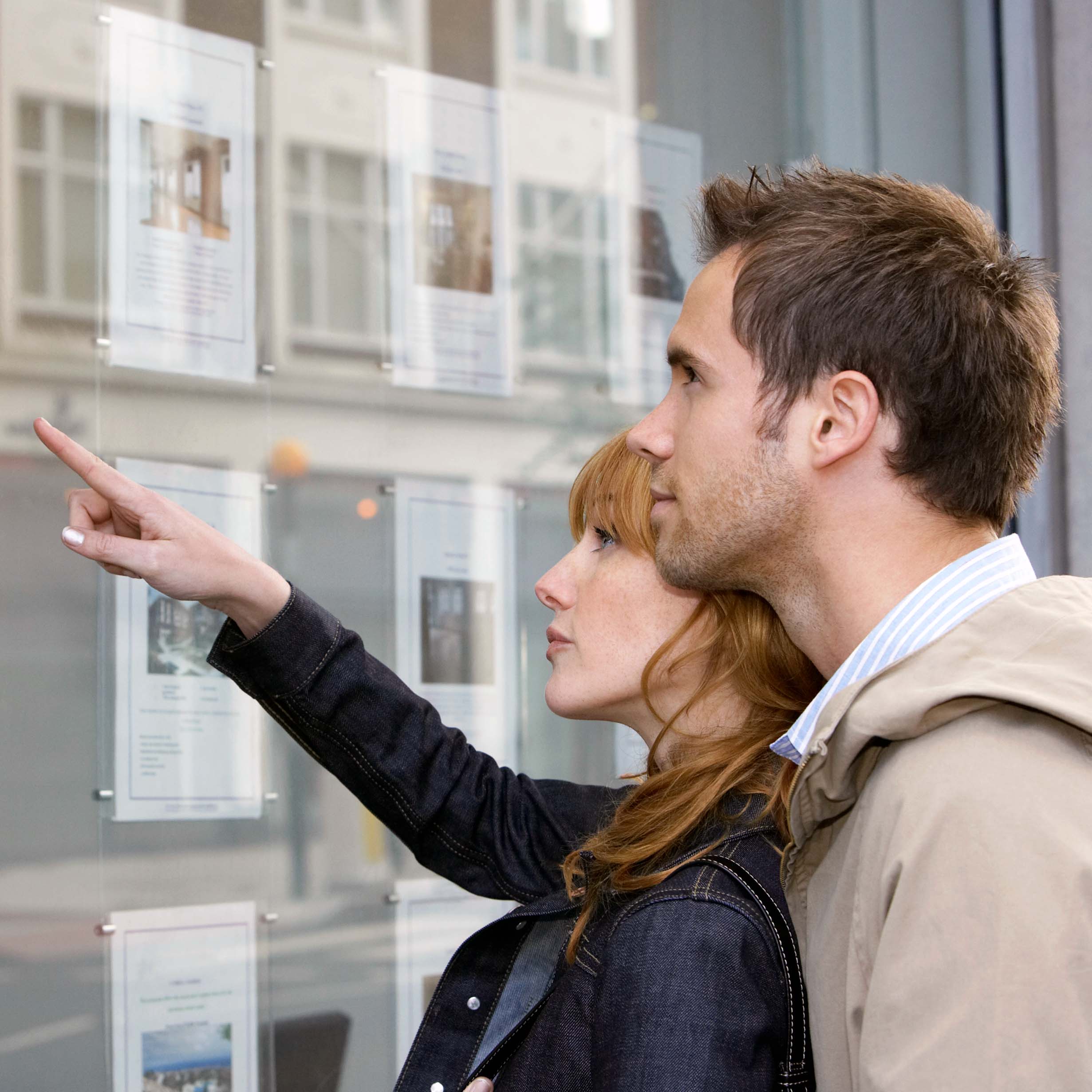 Couple looking at possible estate agents to pick for their own property sale